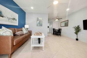 a living room with a couch and a table at Beautiful Madeira Beach 1 Bed Condo With Boat Dock in St. Pete Beach