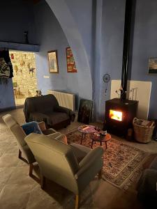 a living room with a couch and a fireplace at Teleport Coliving Cyprus in Pano Lefkara