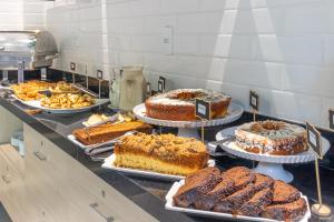 a buffet with cakes and other desserts on display at Hotel Los Angeles in Cuiabá