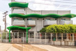 a building with a green staircase in front of it at Hotel Los Angeles in Cuiabá