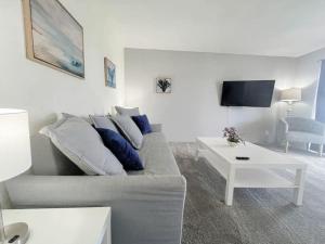 a living room with a couch and a table at Beautiful 2 Bed Beach Condo With DOCK - Walk Everywhere! in St Pete Beach