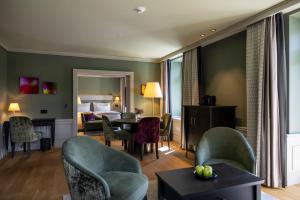 a hotel room with a bed and a table and chairs at Cresta Palace Celerina in Celerina