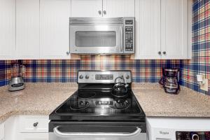 a kitchen with a stove and a microwave at Bluff Villas 1673 in Hilton Head Island