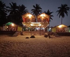 a building on the beach at night at Nana's Nook in Agonda