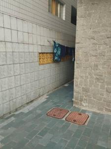 two metal grates on the side of a building at Canto do Forte Apto térreo in Praia Grande