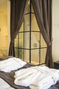 A bed or beds in a room at Magnova Studios