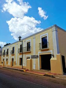 a large white building on the side of a street at Hotel Fundadores in Valladolid