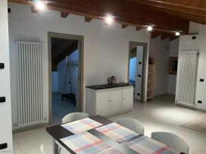 a kitchen with a table and chairs in a room at L'Acero Rosso in Prosto di Piuro