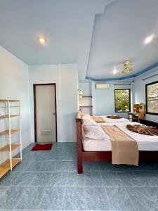 a bedroom with a large bed with a blue ceiling at Euphoria Bungalow in Haad Yao