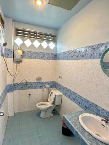 a bathroom with a toilet and a sink at Euphoria Bungalow in Haad Yao