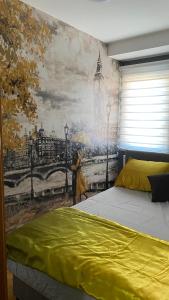 a bedroom with a mural of a woman with an umbrella at Town Square Apartment in Brčko