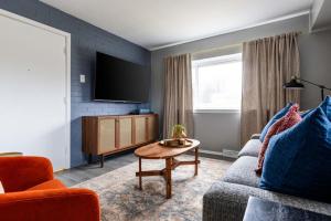 a living room with a couch and a tv at Westlake Elegance - Detroit Unit 3 in Westlake