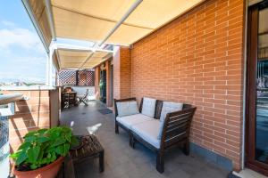 a patio with a chair and a brick wall at Home Around in Rome