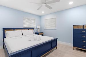 - une chambre avec un lit et un ventilateur de plafond dans l'établissement Caloosa Cottage at Palm View Inn of Sanibel with Bikes, à Sanibel