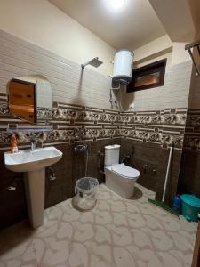 a bathroom with a sink and a toilet at Grham Hostel Kasol, Katagla in Kasol