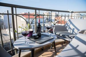 two glasses of wine on a table on a balcony at City Kiss in Orestiada