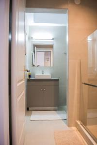 a bathroom with a sink and a mirror at City Kiss in Orestiada +44 photos