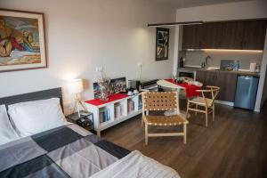 a bedroom with a bed and a kitchen with a table at City Kiss in Orestiada