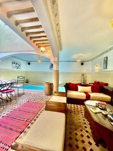 a living room with a couch and a table at Riad Atlas Toyours in Marrakesh