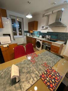 a kitchen with a table with two mats on it at Apartament Czytelnia - parking gratis in Poznań