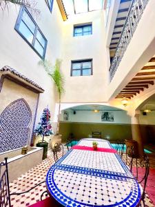 a room with a table and chairs in a building at Riad Atlas Toyours in Marrakesh