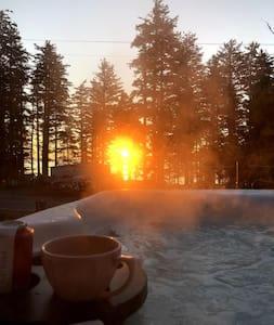 a cup of coffee sitting on a table next to a pool at The Shoreline Legacy House with Hot Tub & Fireplace in Kodiak