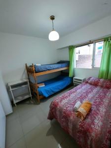 a bedroom with a bed and a window at Depto céntrico de 3 habitaciones y cochera in Rosario