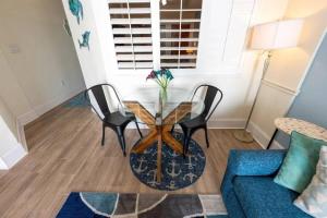 a living room with a glass table and chairs at Your Beachfront Resort Oasis in Myrtle Beach