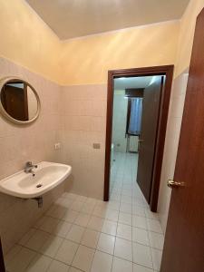 a bathroom with a sink and a mirror at Hotel Battaglia in Battaglia Terme