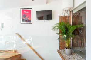 a white room with plants and a tv on a wall at Lisbon Skyline Terrace in Lisbon