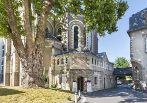 un vieux bâtiment en pierre avec une tour dans l'établissement SOZO Hotel, à Nantes