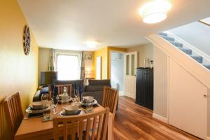 a dining room and living room with a table and chairs at New 2 bed home with off-road parking sleeps 6 in Brockhurst