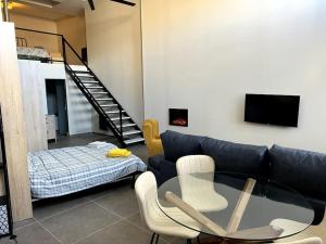 a living room with a glass table and a couch at El Gallinero, Loft con sauna y jacuzzi - Housevanlive in Casas Altas