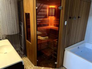 a bathroom with a shower and a sink and a tub at El Gallinero, Loft con sauna y jacuzzi - Housevanlive in Casas Altas +52 photos