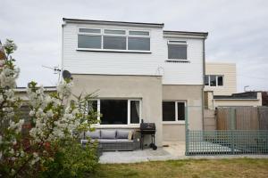 a house with a couch in front of it at 2 Bed Flat with garden nr Beach in South Hayling