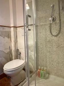 a bathroom with a toilet and a glass shower at Martina a Piazza del Popolo in Rome