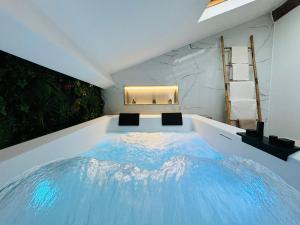 a room with a bed in the middle of it at Love & Spa Fréjus in Fréjus