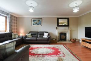 a living room with a couch and a fireplace at Large family home pool table in Waterlooville