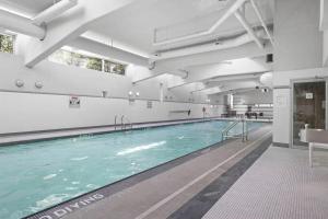 a large swimming pool in a building at Skyline Hideaway in Vancouver