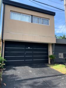 a house with a garage door at Departamento Parana 2 in Posadas
