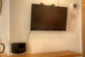 a flat screen tv hanging on a wall at Stunning Solent View Beachfront Apartment, Sleeps4 in South Hayling
