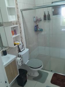 a bathroom with a toilet and a glass shower at Hostel bons sonhos Um Quarto uma Cama de Casal in Penha