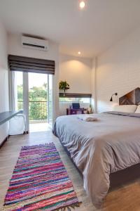 a bedroom with a large bed and a rug at Rumah Kamang Residence in Jakarta