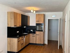 a kitchen with wooden cabinets and black counter tops at Sonnseit 21 in Grossarl