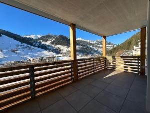 a balcony with a view of snow covered mountains at Sonnseit 21 in Grossarl