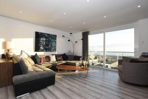 ein Wohnzimmer mit einem Sofa und einem Tisch in der Unterkunft Amazing view High end beachfront 3BR 5beds 7 guest in South Hayling