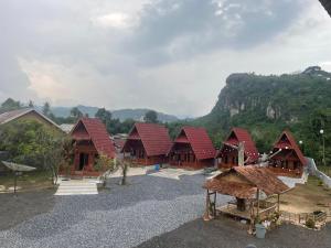 a group of houses with a mountain in the background at "Sakinah" Homestay Syariah AC in Sarilamak