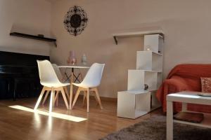 a bedroom with a table and two chairs and a bed at La Morada de Toledo in Toledo