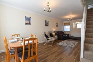 a dining room and living room with a table and chairs at Centrally Located 3Bed Family Home in Portsmouth