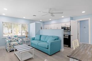 a living room with a blue couch and a table at Caloosa Retreat- 2BR at Palmview Inn Sanibel in Sanibel